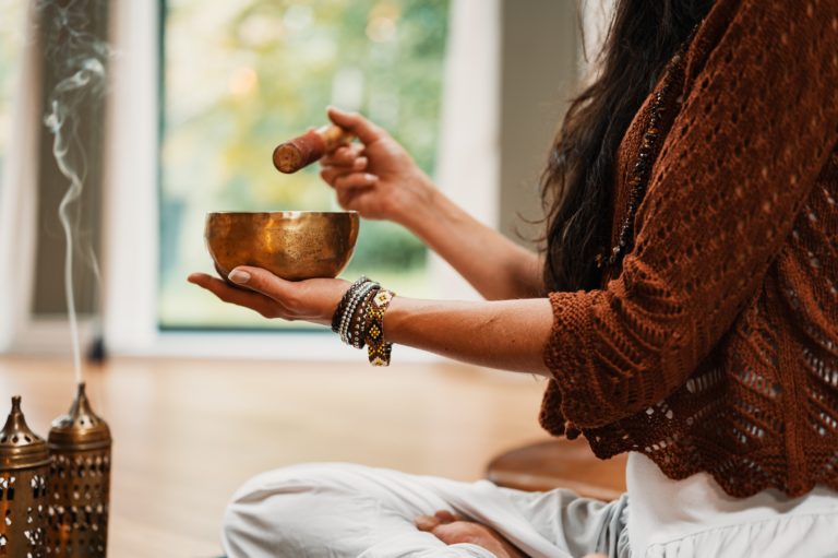 woman with singing meditation bowl